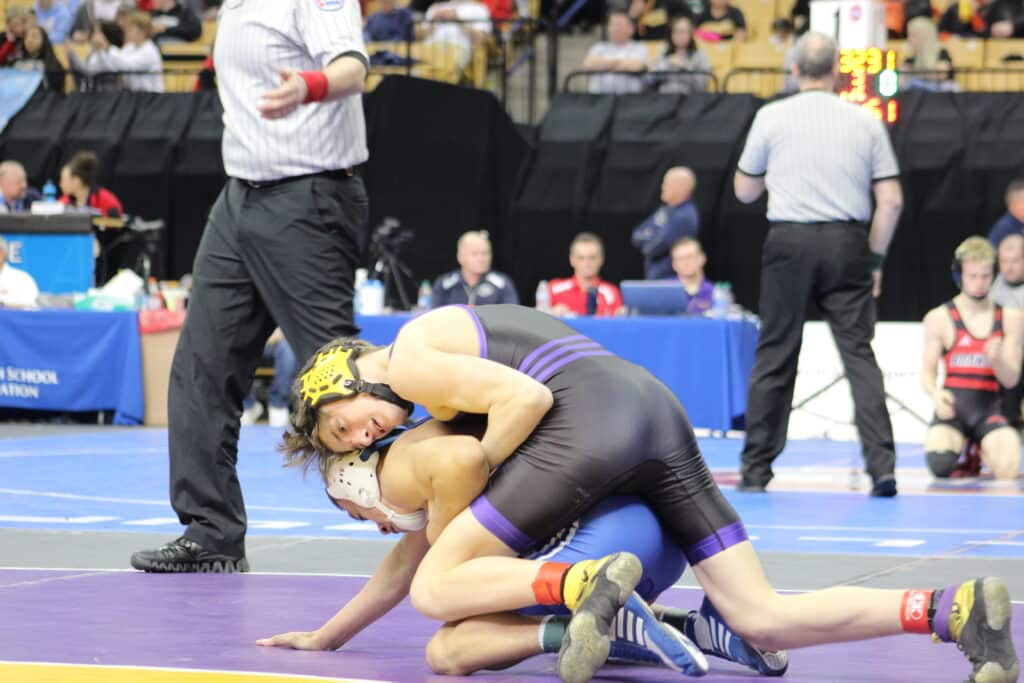 Senior Kale Schrader battles for the eventual win in his state quarterfinal match against Liberty.